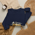 Navy North Woods Moose Crewneck laid flat next to a woven basket and knit blanket