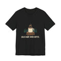 Cold Camp, Good Coffee Tee in Black, front view with a steaming enamel mug on a pine stump above the words 'Cold Camp. Good Coffee.'
